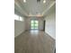 Large bedroom with tile floors, tray ceiling, and sliding glass doors leading to the backyard at 384 Prineville St, Port Charlotte, FL 33954