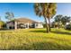 Exterior view of home with screened lanai and lush, green lawn at 4695 Kennett St, North Port, FL 34288