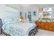 Bedroom with a wooden dresser and beach-themed bedding at 5301 Almar Dr, Punta Gorda, FL 33950