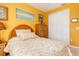 Bedroom with wood armoire and yellow walls at 5301 Almar Dr, Punta Gorda, FL 33950