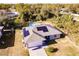 Aerial view of a house with solar panels and a circular pool at 5325 Cillette Ave, North Port, FL 34288
