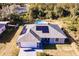 Aerial view of a house with solar panels and a circular pool at 5325 Cillette Ave, North Port, FL 34288
