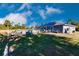 Spacious backyard with a swimming pool, patio furniture, and solar panels at 5325 Cillette Ave, North Port, FL 34288