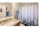 Bathroom with granite countertop, shower/tub combo, and seashell decor at 5325 Cillette Ave, North Port, FL 34288