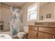 Clean bathroom with shower/tub combo, granite vanity, and seashell-themed decor at 5325 Cillette Ave, North Port, FL 34288