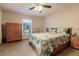 Bedroom with floral bedding, ceiling fan, and wooden dresser at 5325 Cillette Ave, North Port, FL 34288