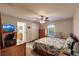 Bedroom with floral bedding, ceiling fan, and wooden dresser at 5325 Cillette Ave, North Port, FL 34288