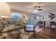 Living room with hardwood floors, floral couch, and ceiling fan at 5325 Cillette Ave, North Port, FL 34288