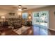 Living room with hardwood floors, floral couch, and sliding doors to backyard at 5325 Cillette Ave, North Port, FL 34288