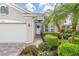 Front entrance with walkway, landscaping, and palm trees at 5355 White Ibis Dr, North Port, FL 34287