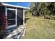 Screened porch with a checkered walkway and lush backyard at 712 Edmund St, Punta Gorda, FL 33950