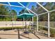 Spacious pool patio with lounge chairs and umbrella at 7345 Cameo Cir, North Port, FL 34291