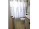 Modest bathroom featuring a floral shower curtain and marble-esque countertops at 806 Hickory Ln, Bradenton, FL 34208