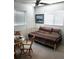 Sunny bedroom with daybed, accent paintings, and chair by multiple windows at 806 Hickory Ln, Bradenton, FL 34208