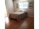 Comfortable bedroom featuring hardwood floors, a cozy quilt, and bright natural light at 806 Hickory Ln, Bradenton, FL 34208