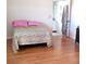 Bedroom with a colorful bedspread and pink pillows, plus a bathroom doorway at 806 Hickory Ln, Bradenton, FL 34208