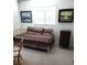 Bright bedroom with daybed, accent paintings, and chair by window at 806 Hickory Ln, Bradenton, FL 34208