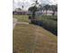 Well-kept community grounds with manicured lawn, mature trees, and visible community buildings in the background at 806 Hickory Ln, Bradenton, FL 34208