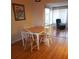 Inviting dining area featuring a light wood table with four chairs and hardwood floors at 806 Hickory Ln, Bradenton, FL 34208