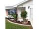 Front entry features peach door, covered porch, and decorative plants at 806 Hickory Ln, Bradenton, FL 34208