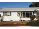 Charming single-story home with manicured lawn and freshly painted white exterior, complete with pleasant landscaping at 806 Hickory Ln, Bradenton, FL 34208