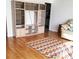 Bright living room boasting hardwood floors, a spacious entertainment center and a multicolored area rug at 806 Hickory Ln, Bradenton, FL 34208