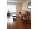 Warm and inviting living room showcasing hardwood floors, a comfortable sofa, and relaxing rocking chair at 806 Hickory Ln, Bradenton, FL 34208