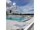Enjoy the community pool with lounge chairs for relaxing by the sparkling water under the blue sky at 806 Hickory Ln, Bradenton, FL 34208