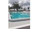 Community pool with a white fence and several trees surrounding the area, great for relaxing and cooling off at 806 Hickory Ln, Bradenton, FL 34208