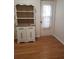 Cozy room with hardwood floors, a charming hutch, and a doorway adorned with a lace curtain at 806 Hickory Ln, Bradenton, FL 34208
