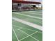 Organized shuffleboard area featuring multiple lanes, benches and a clubhouse, promoting active community engagement at 806 Hickory Ln, Bradenton, FL 34208