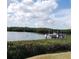 Picturesque waterfront view featuring a private boat lift and lush vegetation, perfect for boating enthusiasts at 806 Hickory Ln, Bradenton, FL 34208