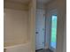 Bright bathroom with a large tub and access to the backyard from the door at 9159 Melody Cir, Port Charlotte, FL 33981