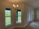 Cozy dining area with large windows and a modern chandelier, perfect for Gathering meals at 9159 Melody Cir, Port Charlotte, FL 33981