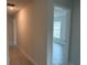 Hallway with tile flooring leading to bedroom with natural light at 9159 Melody Cir, Port Charlotte, FL 33981
