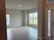 Spacious living room featuring a large window, wood-look tile flooring and neutral walls at 9159 Melody Cir, Port Charlotte, FL 33981