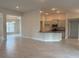 Bright and open living area with tile floors and a view of the kitchen and front entrance at 9159 Melody Cir, Port Charlotte, FL 33981