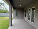 Covered patio features a neutral color, two door access points and a view of the backyard at 9159 Melody Cir, Port Charlotte, FL 33981