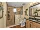 Bathroom with walk in shower, built-in seat, and grab bars at 10055 Links Ln # 306, Rotonda West, FL 33947