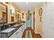 Elegant bathroom with double vanity, dark countertop and walk-in shower at 10055 Links Ln # 306, Rotonda West, FL 33947