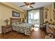 Bright bedroom with floral bedding, wood floors, and access to a balcony at 10055 Links Ln # 306, Rotonda West, FL 33947