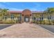 Inviting community entrance with a brick walkway and landscaping at 10055 Links Ln # 306, Rotonda West, FL 33947