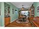 Cozy dining area with wooden table and chairs, built-in hutch and hardwood floors at 10055 Links Ln # 306, Rotonda West, FL 33947