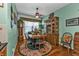 Charming dining room with hardwood floors, wooden table and hutch at 10055 Links Ln # 306, Rotonda West, FL 33947