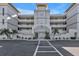 Condo building showcasing a grand entrance and landscaping at 10055 Links Ln # 306, Rotonda West, FL 33947