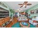 Living room with hardwood floors, wicker furniture and access to balcony at 10055 Links Ln # 306, Rotonda West, FL 33947