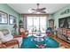 Spacious living room with hardwood floors, wicker furniture and a view of the golf course at 10055 Links Ln # 306, Rotonda West, FL 33947