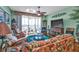 Relaxing living room with wicker furniture, hardwood floors and sliding glass doors to balcony at 10055 Links Ln # 306, Rotonda West, FL 33947