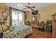 Bright main bedroom with floral bedding, hardwood floors and access to balcony at 10055 Links Ln # 306, Rotonda West, FL 33947