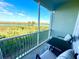 Screened-in balcony with chairs, table, and picturesque views at 10350 Longshore Rd # 61, Placida, FL 33946